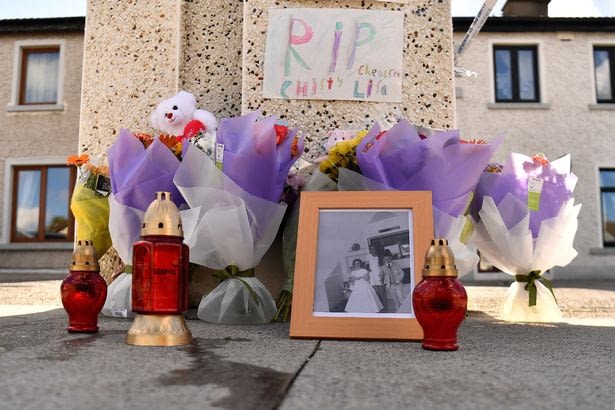 Flowers, a photograph and candles are left near the scene where the trio were killed